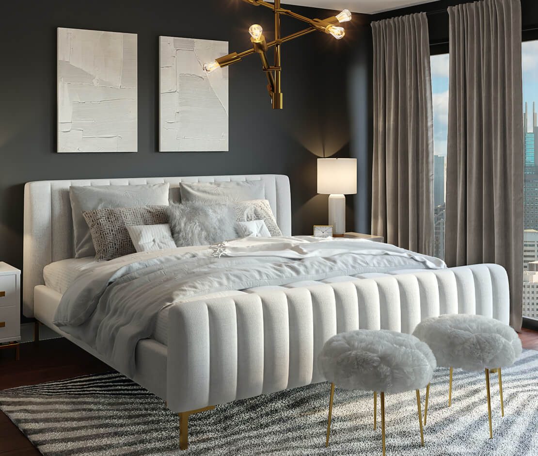 Elegant bedroom with tufted bed and gold accents.