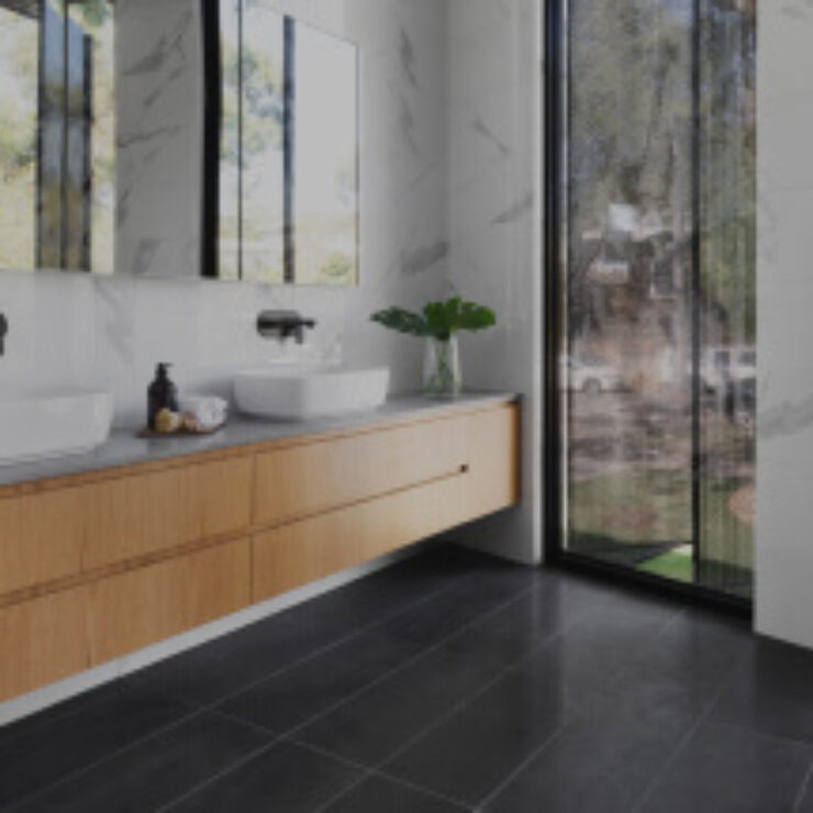 Modern bathroom with wood vanity and large window.