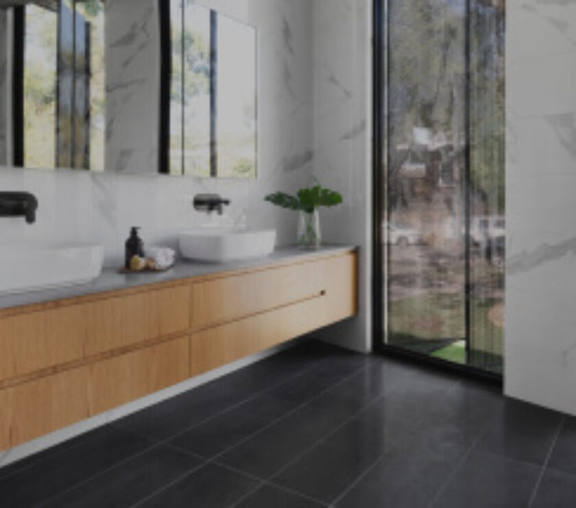 Modern bathroom with wood vanity and large window.