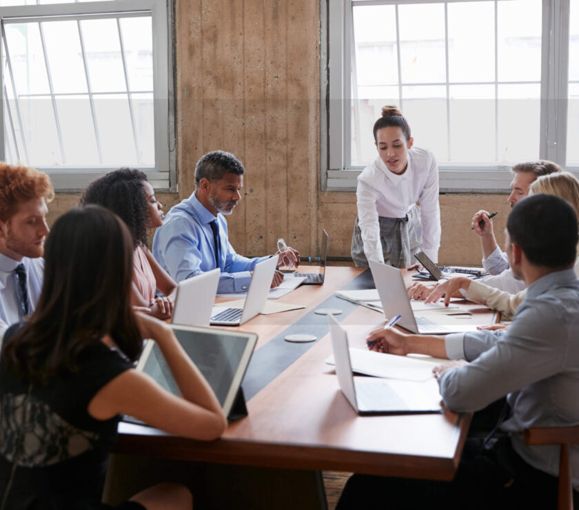 Team meeting with diverse professionals collaborating around a table.