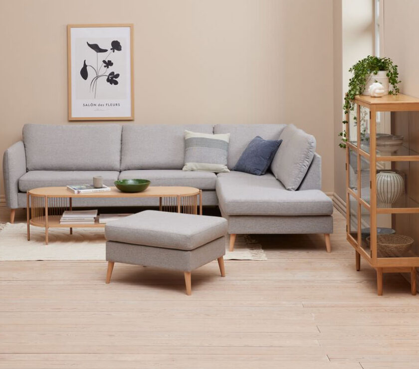 A modern living room with a gray sofa and ottoman.