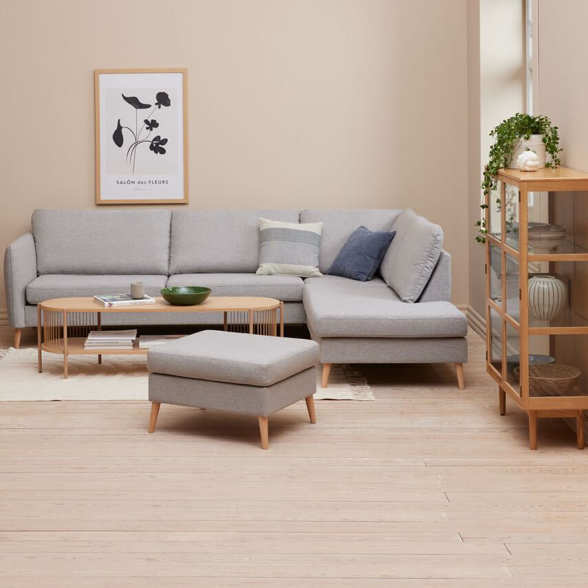 A modern living room with a gray sofa and ottoman.