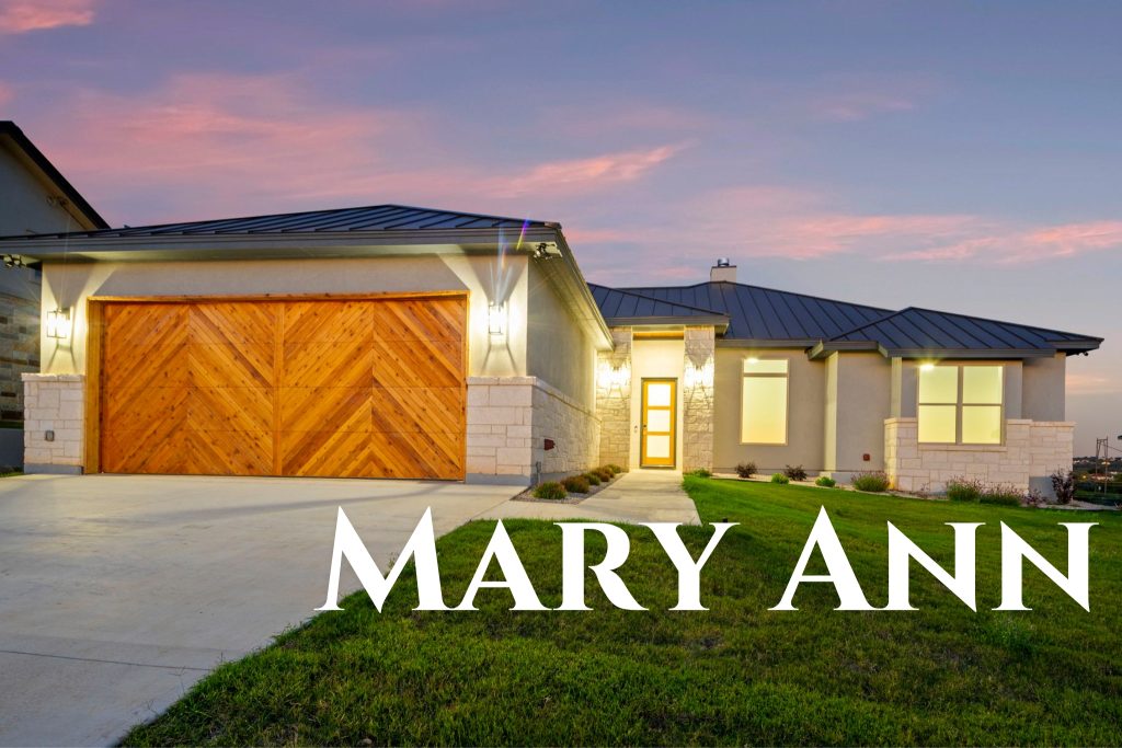 Modern house with a wooden garage door at sunset.